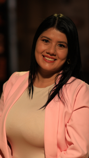 Foto de Alexandra Molina: mujer en plano medio sonriendo con blusa color hueso y blazer rosado.